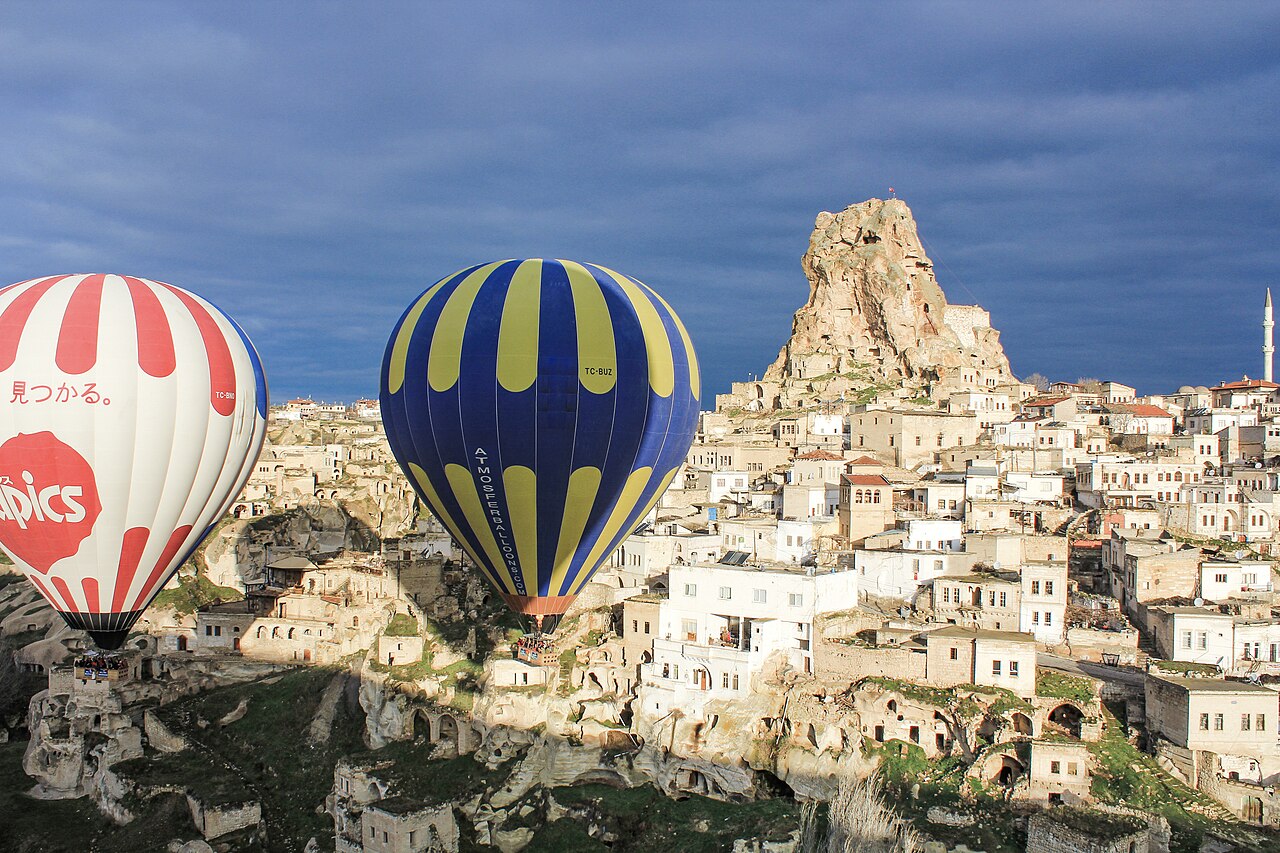 Ortahisar Castle and balloons in Cappadocia, Turkey